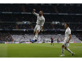 Real Madrid's Dani Carvajal, left, celebrates after Valencia's Daniel Wass scored an own goal during a Spanish La Liga soccer match between Real Madrid and Valencia at the Santiago Bernabeu stadium in Madrid, Spain, Saturday, Dec. 1, 2018.