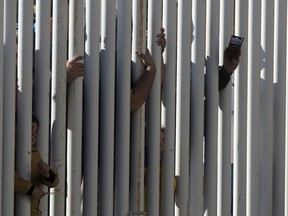 Boca Junior fans try to get a glimpse of their team during a training session in Madrid, Spain, Thursday, Dec. 6, 2018. The Copa Libertadores Final will be played on Dec. 9 in Spain at Real Madrid's stadium for security reasons after River Plate fans attacked the Boca Junior team bus heading into the Buenos Aires stadium for the meeting of Argentina's fiercest soccer rivals last Saturday.