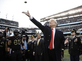 President Donald Trump tosses the coin before the Army-Navy NCAA college football game Saturday, Dec. 8, 2018, in Philadelphia.