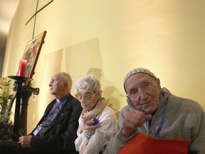 This picture dated Friday, Dec. 7, 2018, shows French Catholic monk Brother Jean-Pierre Schumacher, right, the last survivor of the hostage taking of the seven monks of Tibhirine during the Algerian civil war in 1996, attend a spiritual vigil at the Roman Catholic Cathedral of St Mary in Oran, northwestern Algeria, ahead of the monks' and 12 other clergymen's beatification in the first ceremony of its kind in a Muslim nation. Seven French monks were kidnapped and killed by a radical group at the height of the insurgency in 1996.
