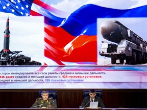 Deputy Chief of General Staff of Russia Valery Gerasimov, left, delivers his speech during a briefing in the Russian Defense Ministry's headquarters in Moscow, Russia, Wednesday, Dec. 5, 2018. Gen. Valery Gerasimov, chief of staff of the Russian military, told a briefing of foreign military attaches on Wednesday that if the U.S. "were to destroy" the treaty "we will not leave it without a response."