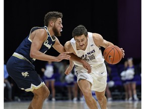 Furman's Clay Mounce drives against Charleston Southern's Travis McConico during the first half of an NCAA college basketball game Tuesday, Dec. 11, 2018, in Greenville, S.C.