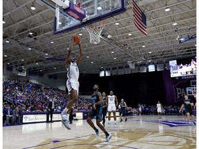 Furman's Jordan Lyons, right, looks to pass while defended by South Carolina Upstate's Pat Welch during the first half of an NCAA college basketball game Saturday, Dec. 8, 2018, in Spartanburg, S.C.