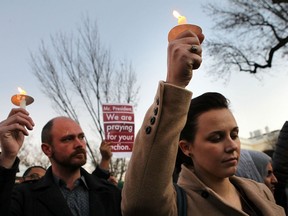 Julie Henson of San Francisco joins other people outside the White House to participate in a candle light vigil to remember the victims at the Sandy Hook Elementary School shooting in Newtown, Connecticut on December 14, 2012 in Washington, DC.