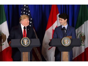 Prime Minister Justin Trudeau, right, and President of the United States Donald Trump participate in a signing ceremony for the new United States-Mexico-Canada Agreement with President of Mexico Enrique Pena Nieto (not shown) in Buenos Aires, Argentina on Friday, Nov. 30, 2018.