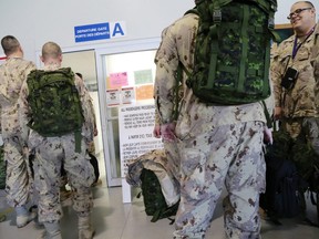 Some of the 104 troops from various Canadian Armed Forces bases who will served in Iraq during Operation Impact board a C-150 Polaris at 8 Wing/CFB Trenton, Ont. Thursday, Oct. 23, 2014.