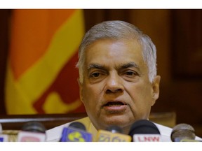 FIEL - In this Dec. 4, 2018, file photo, ousted Sri Lankan prime minister Ranil Wickremesinghe speaks during a media briefing in Colombo, Sri Lanka. The former Sri Lankan prime minister whose October sacking by the president precipitated a political crisis has won a confidence vote in Parliament.
