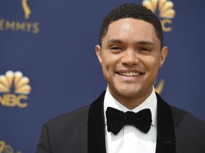 FILE- In this Sept. 17, 2018, file photo, Trevor Noah arrives at the 70th Primetime Emmy Awards at the Microsoft Theater in Los Angeles. Trevor Noah appeared as usual on "The Daily Show," but his voice didn't. The host relied on fellow Comedy Central correspondents to read his monologue, instead. It's unclear how long he will be unable to speak or what caused the problem.