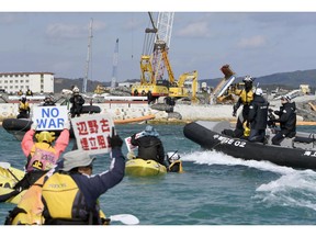 FILE - In this Dec. 6, 2018, file photo, Japan's Coast Guard ship, top, and U.S. military plane are seen at sea off Kochi, southwestern Japan, during a search and rescue operation for missing crew members of a U.S. Marine refueling plane and fighter jet. The U.S. Marine Corps have declared that five crewmembers dead after their aircraft crashed last week off Japan's southern coast and that their search has ended. (Kyodo News via AP, File)