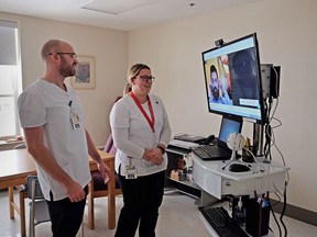 Nurses use a TV cart with a doctor on a secure video conference link during a pilot project of "tele-rounding" in Alberton, P.E.I., in this undated handout photo. A rural hospital in western P.E.I. is using an innovative, first-in-Canada, approach to delivering care to patients that could offer a solution to doctor shortages at hospitals across the country.