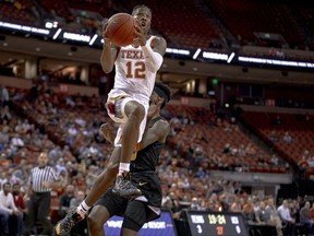 Texas guard Kerwin Roach II (12) tries for a layup during an NCAA college basketball game against Virginia Commonwealth in Austin, Texas, on Wednesday, Dec. 5, 2018.