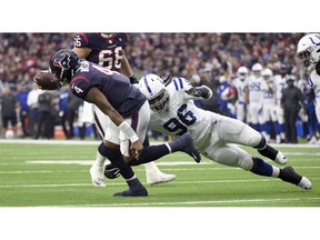 Houston Texans quarterback Deshaun Watson (4) is tackled by Indianapolis Colts defensive tackle Denico Autry (96) during the first half of an NFL football game Sunday, Dec. 9, 2018, in Houston.