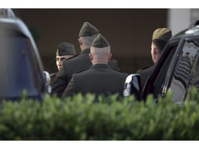 Members of a color guard gather outside the George H. Lewis Funeral Home as they prepare for a departure ceremony for the state funeral for former President George H.W. Bush, Monday, Dec. 3, 2018, in Houston.