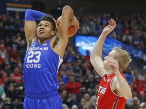 BYU forward Yoeli Childs (23) dunks on Utah guard Parker Van Dyke (5) in the first half during an NCAA college basketball game Saturday Dec. 8, 2018, in Salt Lake City.