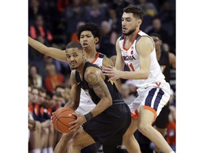 Virginia Commonwealth guard Marcus Evans (2) is pressured by Virginia guards Kihei Clark (0) and Ty Jerome (11) during an NCAA college basketball game Sunday, Dec. 9, 2018, in Charlottesville, Va.