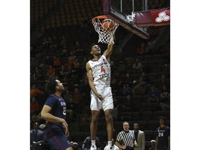 Virginia Tech's Nickeil Alexander-Walker (4) dunks over South Carolina State's David Bottenberg during an NCAA college basketball game in Blacksburg, Va., Sunday, Dec. 9, 2018.