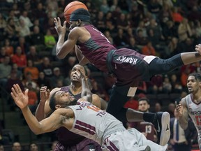 Virginia Military guard Greg Parham (5) looks to shoot against Virginia Tech guard Justin Robinson (5) during the first half of an NCAA college basketball game Wednesday, Dec. 5, 2018, in Blacksburg, Va.
