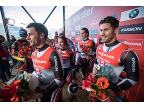 Canada's Reid Watts, from left, Kyla Graham, Justin Snith and Tristan Walker hold flowers after finishing third in a World Cup luge relay event in Whistler, B.C., on Saturday, Dec. 1, 2018.