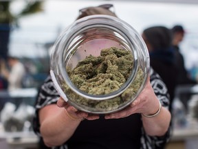 A vendor displays marijuana for sale during the 4-20 annual marijuana celebration in Vancouver on April 20, 2018.