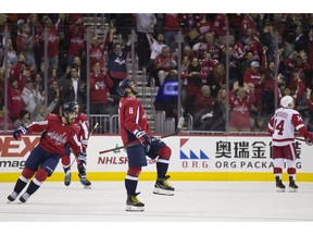 Washington Capitals left wing Alex Ovechkin (8), from Russia, celebrates his goal with defenseman Michal Kempny, from the Czech Republic, at left, in the first period of an NHL hockey game against the Detroit Red Wings, , Tuesday, Dec. 11, 2018, in Washington.