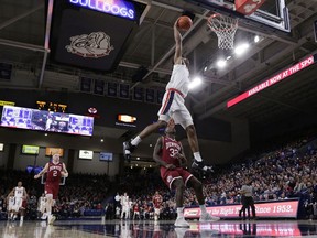 Washington guard Jaylen Nowell, right, shoots while defended by Gonzaga forward Brandon Clarke (15) during the first half of an NCAA college basketball game in Spokane, Wash., Wednesday, Dec. 5, 2018.