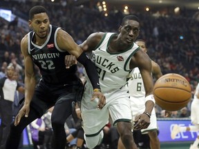 Detroit Pistons' Glenn Robinson III (22) and Milwaukee Bucks' Tony Snell fight for a rebound during the first half of an NBA basketball game Wednesday, Dec. 5, 2018, in Milwaukee.