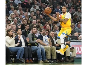 Milwaukee Bucks' George Hill saves a ball during the first half of an NBA basketball game against the Cleveland Cavaliers Monday, Dec. 10, 2018, in Milwaukee.