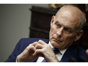 In this June 21, 2018 photo, White House chief of staff John Kelly listens as President Donald Trump speaks during a lunch with governors in the Roosevelt Room of the White House in Washington. Trump says chief of staff John Kelly will leave his job at the end of the year.