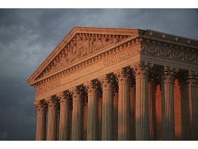 In this Oct. 4, 2018 photo, the U.S. Supreme Court is seen at sunset in Washington.   The Supreme Court is avoiding a high-profile case by rejecting appeals from Kansas and Louisiana in their effort to strip Medicaid money from Planned Parenthood over the dissenting votes of three justices.