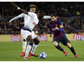 Barcelona forward Lionel Messi, right, vies for the ball with Tottenham midfielder Moussa Sissoko during the Champions League group B soccer match between FC Barcelona and Tottenham Hotspur at the Camp Nou stadium in Barcelona, Spain, Tuesday, Dec. 11, 2018.