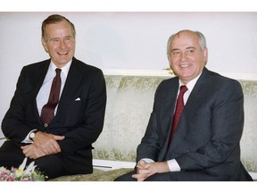 FILE - In this file photo taken on Tuesday, Oct. 29, 1991, U.S. President George H. Bush, left, and Soviet President Mikhail Gorbachev sit together at the Soviet Embassy after meeting in Madrid, Spain. Former Soviet premier Mikhail Gorbachev expressed his "deep condolences" Saturday Dec. 1, 2018, to the family of former U.S President George Bush and all Americans following his death, aged 94.