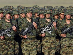 In this photo taken on Tuesday, Oct. 17, 2017, Serbian Army soldiers perform during rehearsal exercise in Batajnica, military airport near Belgrade, Serbia. Serbia's prime minister warned on Wednesday, Dec. 5, 2018 that the formation of a Kosovo army could trigger Serbia's armed intervention in the former province -- the bluntest warning so far amid escalating tensions in the Balkans.