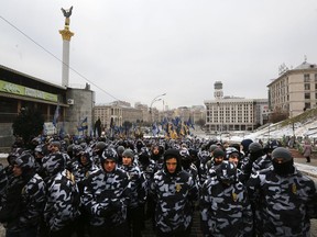 Volunteers with the right-wing paramilitary Azov National Corps attend a rally against Russia in front of the Ukrainian President's office in Kiev, Ukraine, Friday, Dec. 7, 2018. Some hundreds from the far-right party National Corps waved flags and protested.