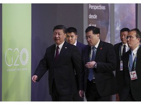 China's President Xi Jinping, left, enters for the start of the G20 summit in Buenos Aires, Argentina, Friday, Nov. 30, 2018. Heads of state from the world's leading economies were invited to the Group of 20 summit to discuss issues like development, infrastructure and investment, but those themes seem like afterthoughts, overshadowed by contentious matters from the U.S.-China trade dispute to the conflict over Ukraine.