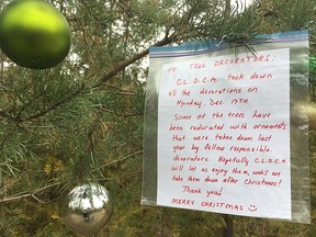 A citizen's note informs tree decorators that the Central Lake Ontario Conservation Authority removed the ornaments from a number of trees in Heber Down, north of Whitby, Ont., on Monday. The trees were redecorated by Wednesday.