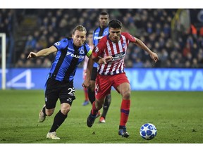 Brugge midfielder Ruud Vormer, left, fights for the ball with Atletico midfielder Rodrigo Hernandez during their Champions League group A soccer match between Club Brugge and Atletico Madrid at the Jan Breydel Stadium in Bruges, Belgium, Tuesday, Dec. 11, 2018.
