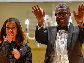 Nobel prize laureates Iraqi Yazidi-Kurdish human rights activist Nadia Murad and Congolese gynecologist Denis Mukwege greet the crowd from the balcony of the Nobel suite in Oslo downtown, Norway on December 10, 2018.