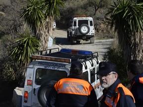 Emergency services look for a 2 year old boy who fell into a well, in a mountainous area near the town of Totalan in Malaga, Spain, Monday, Jan. 14, 2019.