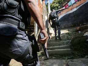 UPP (Pacifying Police Unit) officers patrol in the Babilonia favela community, which stands on a hillside above Copacabana beach, an Olympic venue site, on July 26, 2016 in Rio de Janeiro, Brazil. A wave of violence has swept into some of Rio's 'pacified' favelas in recent months in the midst of a hard-hitting economic recession and fights between drug gangs and police. There are ten days to go before the start of the Rio 2016 Olympic Games.