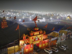 In this Monday, Jan. 14, 2019, photo, a thick layer of dust is seen over the tent city set up for the spiritual-cleansing Kumbh Festival in Prayagraj, India. The skies over the confluence of sacred rivers in north India where millions of Hindu priests and pilgrims have come to wash away their sins for the Kumbh Mela, or pitcher festival, that begins this week are thick with toxic dust, a sign that Indian government officials are struggling to grapple with India's worsening air pollution.