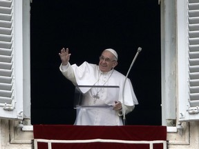 Pope Francis salutes the crowd as he recites the Angelus noon prayer from the window of his studio overlooking St.Peter's Square, at the Vatican, Sunday, Jan. 13, 2019.