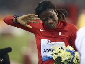 FILE - In this Friday, May 9, 2014 file photo, Kemi Adekoya of Bahrain gestures after winning the 400m hurdles at the IAAF Diamond League in the Qatari capital Doha. Four-time Asian Games champion Kemi Adekoya has been provisionally suspended after testing positive for an anabolic steroid. The Athletics Integrity Unit says a "notice of allegation" was sent to Adekoya. She is a Nigerian-born runner who switched allegiance to Bahrain.