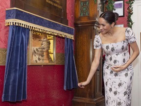 FILE - In this Tuesday, Dec. 18, 2018 file photo, Meghan, the Duchess of Sussex visits the Royal Variety Charity's residential nursing and care home Brinsworth House, in Twickenham, south west London. Meghan, the Duchess of Sussex, is taking an increasingly visible role in the royal family as she becomes the patron of four organizations including the prestigious National Theatre. Kensington Palace said Thursday, Jan. 10, 2019 that Meghan will take over two roles as patron that have for decades been held by Queen Elizabeth II and is taking two other roles as well.