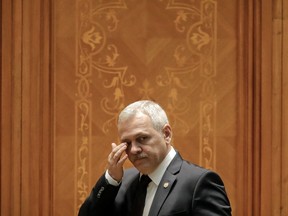 FILE - In this Thursday, Dec. 20, 2018 file photo, Head of the Ruling Social Democratic Party, Liviu Dragnea, wipes his eyes as he joins a parliament session during a no-confidence vote initiated by opposition parties in Bucharest, Romania. Dragnea who has clashed with the European Union over the government's approach to fighting high-level corruption, is expected to miss events marking Romania's six-month presidency of the bloc.