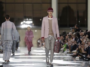 FILE-  In this Friday, June 15, 2018 file photo, a model wears a creation part of the Ermenegildo Zegna men's Spring-Summer 2019 collection, that was presented in Milan, Italy. Italian fashion houses are refashioning themselves for future growth to stay on trend. The Milan Fashion Week devoted to menswear for next fall and winter opens on Friday, Jan. 11, 2019 with Ermenegildo Zegna, which made its first move to expand abroad with the Zegna Group's summer acquisition of American brand Thom Browne.