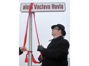 FILE  - In this Friday, Dec. 23, 2011 file photo, Gdansk Mayor Pawel Adamowicz unveils a street renamed in honor of Vaclav Havel, the former Czech president and playwright, in Gdansk, Poland. Poland's health minister says that Gdansk Mayor Pawel Adamowicz has died from stab wounds a day after being attacked onstage by an ex-convict at a charity event, it was reported on Monday, Jan. 14, 2019.