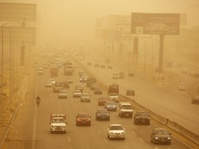 Vehicles drive during a sandstorm in Cairo, Egypt, Wednesday, Jan. 16, 2019 as a thick sandstorm cloaked parts of the Middle East. Sandstorms and harsh weather are blowing through parts of the Middle East, with visibility down in the Egyptian capital as an orange cloud of dust blocked out the sky and pedestrians used fabrics to cover their faces from the gusts.