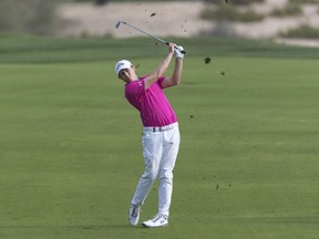 Matthew Fitzpatrick of England hits his second shot on the 14th hole during round two of the Dubai Desert Classic golf tournament in Dubai, United Arab Emirates, Friday, Jan. 25, 2019.