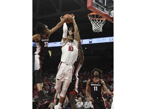 Arkansas forward Daniel Gafford (10) is fouled by Georgia defender Nicolas Claxton (33) as he drives to the hoop during the first half of an NCAA college basketball game, Tuesday, Jan.29, 2019 in Fayetteville, Ark.