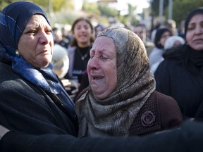 Women cry during the funeral of Israeli Arab student Aiia Maasarwe in Baqa El Gharbiye, Israel, Wednesday, Jan. 23, 2019. Maasarwe, 21, was killed as she was walking on a city street in Melbourne, Australia, speaking to her sister by phone.